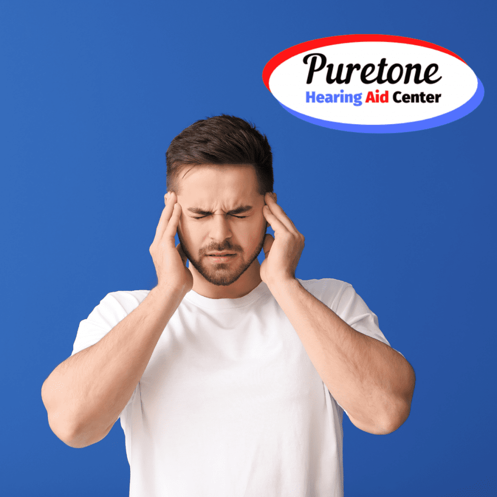 Man standing in front of a blue background and holding his ears in pain.