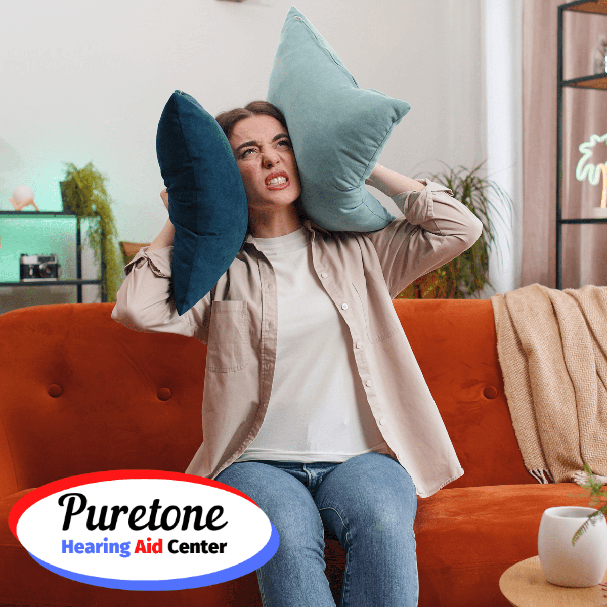 woman holding pillows over her ears