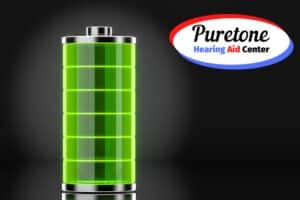 a green battery on a black background